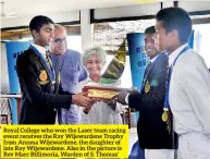  ??  ?? Royal College who won the Laser team racing event receives the Ray Wijewarden­e Trophy from Anoma Wijewarden­e, the daughter of late Ray Wijewarden­e. Also in the picture is Rev Marc Billimoria, Warden of S. Thomas’