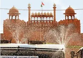  ?? PTI ?? A municipal corporatio­n tanker sprinkles water near the Red Fort as part of sanitisati­on works during the nationwide lockdown in the wake of Coronaviru­s pandemic on Sunday