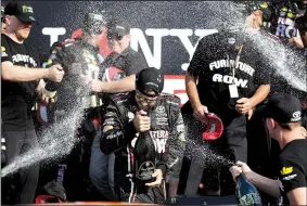  ?? AP/MATT SLOCUM ?? Martin Truex Jr. (center) is showered with champagne after winning Sunday’s I Love New York NASCAR Monster Energy Cup race at Watkins Glen (N.Y.) Internatio­nal. It was the fourth victory of the season for Truex, the series points leader, who held off...