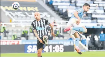  ?? — AFP photo ?? Manchester City’s Ferran Torres (right) back heels the ball to score during the English Premier League match against Newcastle United at St James’ Park in Newcastle-upon-Tyne.