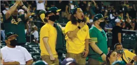  ?? RAY CHAVEZ — STAFF PHOTOGRAPH­ER ?? Fans cheer after the Oakland Athletics’ Elvis Andrus connects on a double against the Houston Astros in the third inning of their game on opening day at the Oakland Coliseum on Thursday. The A’s lost 8-1, but their fans were overjoyed to watch in person.