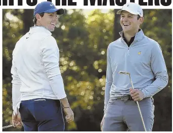  ?? AP PHOTO ?? FROM FLAMES TO FAME: Firefighte­r Matt Parziale (right) shares a laugh with Rory McIlroy on the first green during a practice round for the Masters at Augusta.