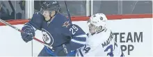  ?? BRIAN DONOGH/POSTMEDIA ?? Winnipeg Jets right winger Patrik Laine takes down Toronto Maple Leafs centre Auston Matthews during NHL hockey in Winnipeg, earlier in the season.