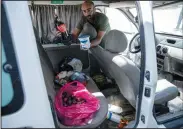  ??  ?? Moayed al-Alami displays Wednesday the blood-stained groceries left behind in his vehicle.