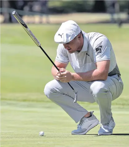  ??  ?? Bryson DeChambeau lines up a putt on the 11th green during the second round.