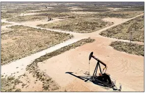  ?? Bloomberg News ?? Pumpjacks operate on oil wells in the Permian Basin in this aerial photograph taken near Crane, Texas, early this month. Along with oil, the basin produced record amounts of natural gas over the past year, but a shortage of pipelines has created a...