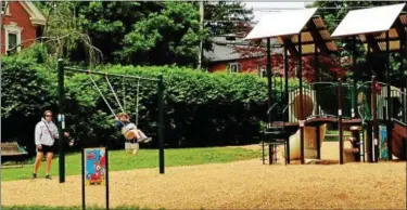  ?? BOB KEELER - DIGITAL FIRST MEDIA ?? A child gets a swing ride in the new playground at Dan Roth Park in Lower Salford.