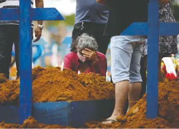  ?? BRUNO KELLY/ REUTERS ?? A woman is despondent during a mass burial of people who passed away due to COVID-19 at the Parque Taruma cemetery in Manaus, Brazil, on Tuesday. Brazil has the second-most coronaviru­s cases in the world.