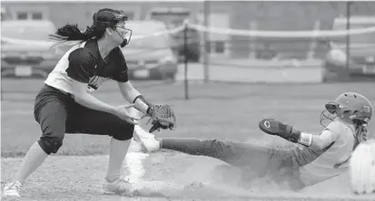  ?? KARL MERTON FERRON/BALTIMORE SUN ?? Wilde Lake’s Heather McQueeney steals third base as Mt. Hebron’s Ashley Cheung is late with the tag during Thursday’s game. McQueeney went 4-for-4 with three extra-base hits and two RBIs in the 7-2 win.