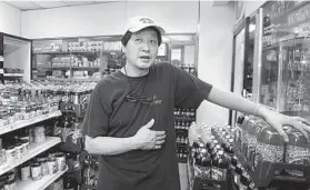  ??  ?? Sung Kim, the manager of A to Z convenienc­e store on Park Heights Avenue, says a quarter of his business comes from food stamps.