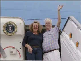  ?? THE ASSOCIATED PRESS ?? In this Sept. 18photo, Christophe­r Jenkins waves while he stands with Julia Mord as they mimic a presidenti­al arrival for a friend who is making their picture during their tour of the “Air Force One Experience,” a full-sized 747replica of Air Force One...