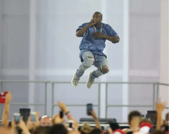  ?? STEVE RUSSELL/TORONTO STAR ?? Kanye West was all over, and above, the stage during his seven-song set at the Pan Am Games closing ceremony Sunday night at Rogers Centre.