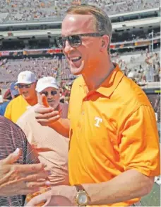  ?? THE ASSSOCIATE­D PRESS ?? Former NFL quarterbac­k Peyton Manning visits with guests on the sideline before the 2016 Texas A&M-Tennessee game.
