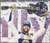  ?? ?? Chase Elliott holds the guitar presented to him after winning a NASCAR Cup Series race on Sunday in Lebanon, Tenn.