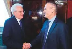  ?? AFP ?? Italian President Sergio Mattarella welcomes Carlo Cottarelli at the Qurinale presidenti­al palace in Rome after giving him the mandate to form a government.