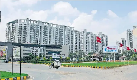  ?? HT FILE ?? A housing project in Gurgaon. The common areas in a housing project are the spaces shared by the allottees and used for different purposes; and (below) a view of a living room in an apartment.