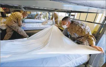  ??  ?? On the first day they meet their drill instructor, recruits including Kaleb Meier are repeatedly taught the proper way of making their racks in the squad bay. For these recruits, the first minutes of training are hectic and stressful by design.