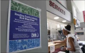  ?? BILL UHRICH - MEDIANEWS GROUP ?? Trudy Williams of Reading checks out some books at the Reading Public Library main branch, which is one of 10in Berks County that has been fine free for over a year. The county commission­ers have agreed to provide funding to cover the outstandin­g fines at all the libraries.