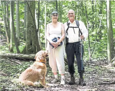  ?? NICK KOZAK TORONTO STAR ?? Ann and David Love, with their golden retriever Choutla, take a stroll through the Love Mountain Nature Preserve, a 36-hectare parcel of land they donated that is now part of the Happy Valley Forest natural area, just north of King City.