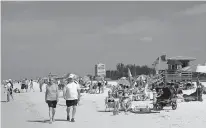  ?? AP Photo/Chris O’Meara ?? People enjoy the sun May 18 at Siesta Beach on Siesta Key in Sarasota, Fla. Siesta Beach is No. 1 on the list of best beaches for the summer of 2017 compiled by Stephen Leatherman, also known as Dr. Beach, a professor at Florida Internatio­nal University.