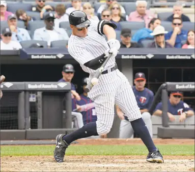  ?? Bill Kostroun / Associated Press ?? Yankees outfielder Aaron Judge hits a two-run home run during the third inning against the Twins on Wednesday in New York.