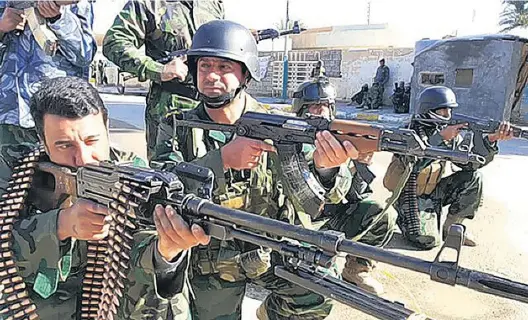  ?? AFP ?? Our enemy’s enemy: Iraqi troops outside Ramadi in 2014, prior to an operation to drive out Isis forces holding the city