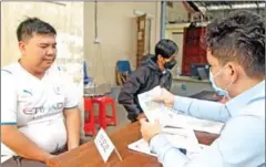  ?? HENG CHIVOAN ?? A man registers to vote at Phsar Doeum Thkov commune in the capital’s Chamkamorn district in October.