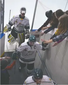  ?? [WHITNEY NEILSON / THE OBSERVER] ?? Captain Jeff Jordan and Jon Reinhart give high fives to fans in high five alley after the game.