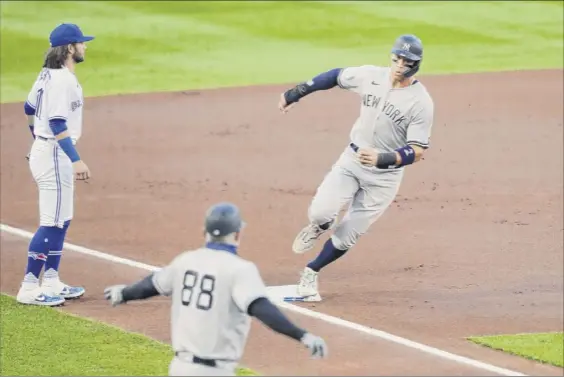  ?? Photos by Timothy T. Ludwig / Getty Images ?? Aaron Judge of the Yankees rounds third to score a run in the first inning in Buffalo on Tuesday night. Judge had three hits to snap a 2-for-17 slump