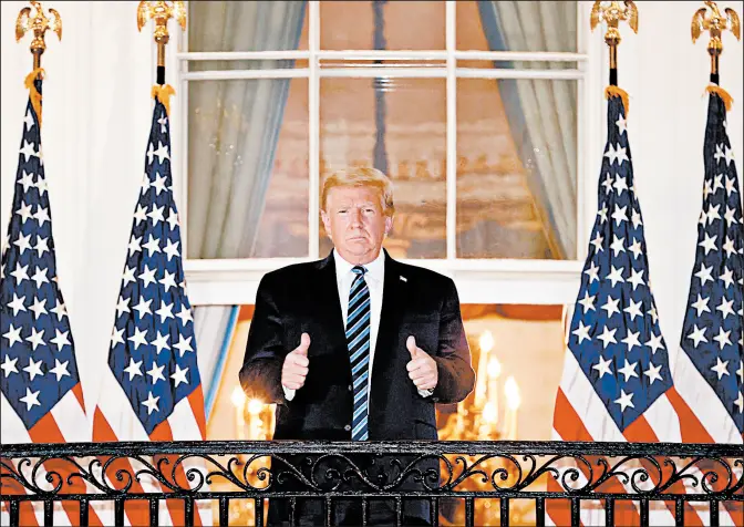  ?? WIN MCNAMEE/GETTY ?? President Trump gives a thumbs-up Monday upon returning to the White House from Walter Reed National Military Medical Center.