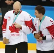  ?? STEVE RUSSELL/TORONTO STAR ?? Team Canada’s Chris Lee, left, and Chay Genoway, right, after receiving their bronze medals.