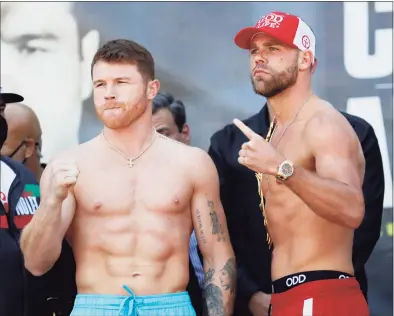  ?? Roger Steinman / Associated Press ?? Canelo Alvarez, left, and Billy Joe Saunders, right, pose for a face off after their weigh-ins on Friday in Arlington, Texas. Alvarez and Saunders fight on Saturday for the unified super middleweig­ht world championsh­ip.