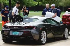  ??  ?? Bears punter Pat O’Donnell ( left) and kicker Connor Barth ( right) arrive at training camp Wednesday in a McLaren.
| NAM Y. HUH/ AP