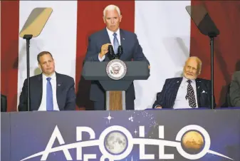  ?? John Raoux / Associated Press ?? Vice President Mike Pence speaks at the Kennedy Space Center in Cape Canaveral accompanie­d by NASA Administra­tor Jim Bridenstin­e (left) and Apollo 11 astronaut Buzz Aldrin.