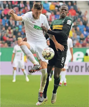  ?? FOTO: IMAGO ?? Zweikämpfe ohne Ende: Denis Zakaria (rechts) im Duell mit Augsburgs Innenverte­idiger Jeffrey Gouweleeuw beim 1:1 am vergangene­n Samstag. Zakaria wurde nach 45 Minuten eingewechs­elt.