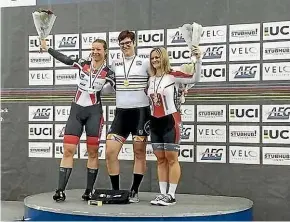  ??  ?? Transgende­r woman Rachel Mckinnon, centre, celebrates her first-place finish at the age-group track cycling world championsh­ips. Third-placed finisher Jennifer Wagner-assali, right, said the result was not fair.