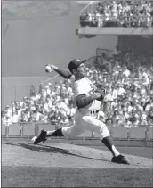  ?? THE ASSOCIATED PRESS — 1965 ?? Dodgers pitcher Sandy Koufax pitches on the mound during the fifth game of the World Series in 1965.
