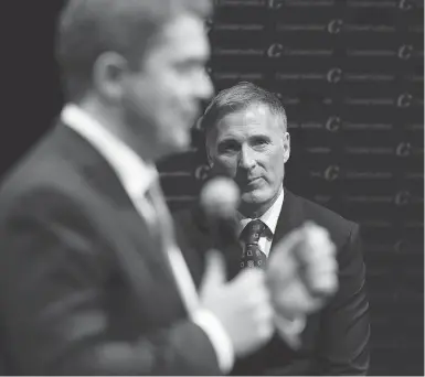  ?? IAN KUCERAK / POSTMEDIA NEWS FILES ?? Maxime Bernier listens to Andrew Scheer during the Conservati­ve leadership debate in February 2017. Bernier’s accusation that Scheer signed up thousands of “fake” voters caused blowback within the party caucus this week.