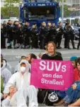  ?? Foto: Boris Roessler, dpa ?? Aktivisten von „Sand im Getriebe“vor der IAA.