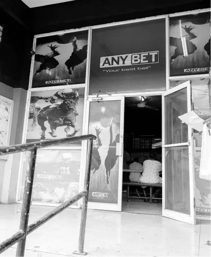  ?? GLADSTONE TAYLOR/PHOTOGRAPH­ER ?? Persons are seated inside a Any bet shop operated by Post to Post Betting on Thursday, August 1, 2019. The Fair Trade Commission is examining the takeover of the bookmaker by Supreme Ventures to determine whether it is anti-competitiv­e.