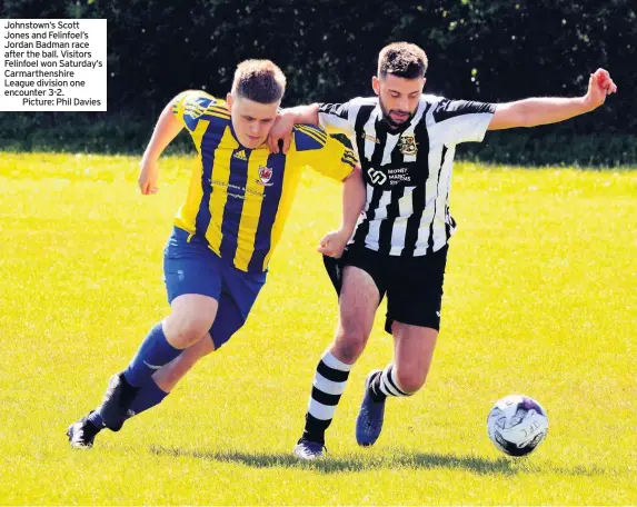  ??  ?? Johnstown’s Scott Jones and Felinfoel’s Jordan Badman race after the ball. Visitors Felinfoel won Saturday’s Carmarthen­shire League division one encounter 3-2.
Picture: Phil Davies