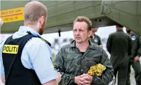  ??  ?? Peter Madsen speaks to Danish police after being rescued south of Copenhagen in August 2017, shortly before his submarine sank. Photograph: Bax Lindhardt/EPA