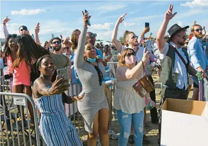  ?? KIM HAIRSTON/BALTIMORE SUN ?? People enjoy a concert by 2 Chainz at the 146th Preakness Stakes.