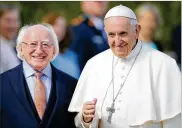  ?? PETER MORRISON / AP ?? Pope Francis is flflanked by Irish President Michael D. Higgins at the Presidenti­al residence Saturday in Dublin, Ireland. Pope Francis faced a lukewarm reception and scattered protests from the public.