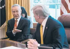  ?? JIM WATSON/GETTY-AFP ?? China’s Vice Premier Liu He, left, speaks with President Donald Trump during a trade meeting in April.