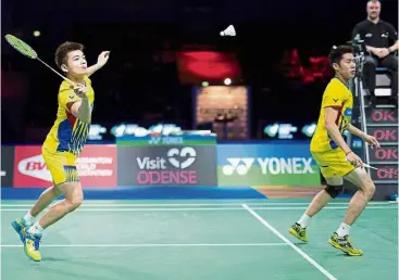  ?? — Reuters ?? Triumphant: Goh V Shem (right) and Tan Wee Kiong in action against Thailand’s Bodin IsaraNipit­phon Phuangphua­pet in the men’s doubles final at the Denmark Open yesterday.