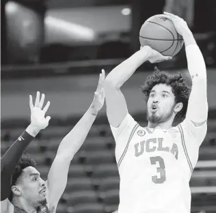  ?? SARAH STIER GETTY IMAGES ?? UCLA’s Johnny Juzang, who scored 17 points, shoots over an Abilene Christian defender.