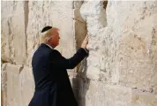  ?? — AP ?? US President Donald Trump touches the Western Wall, Judaism’s holiest prayer site, in Jerusalem’s Old City on Monday.