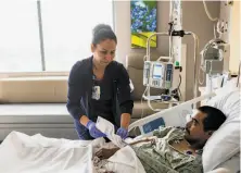  ?? Dominic Valente / New York Times ?? Registered nurse Lourdes Sorreles cares for Pablo Lopaz Romero at Banner-University Medical Center Phoenix.