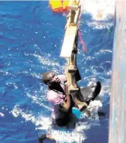  ?? Associated Press ?? Footage emerged Tuesday, filmed by a crew member, showing a Mediterran­ean Sea rescue of migrants on a sinking vessel trying to get aboard a freighter.